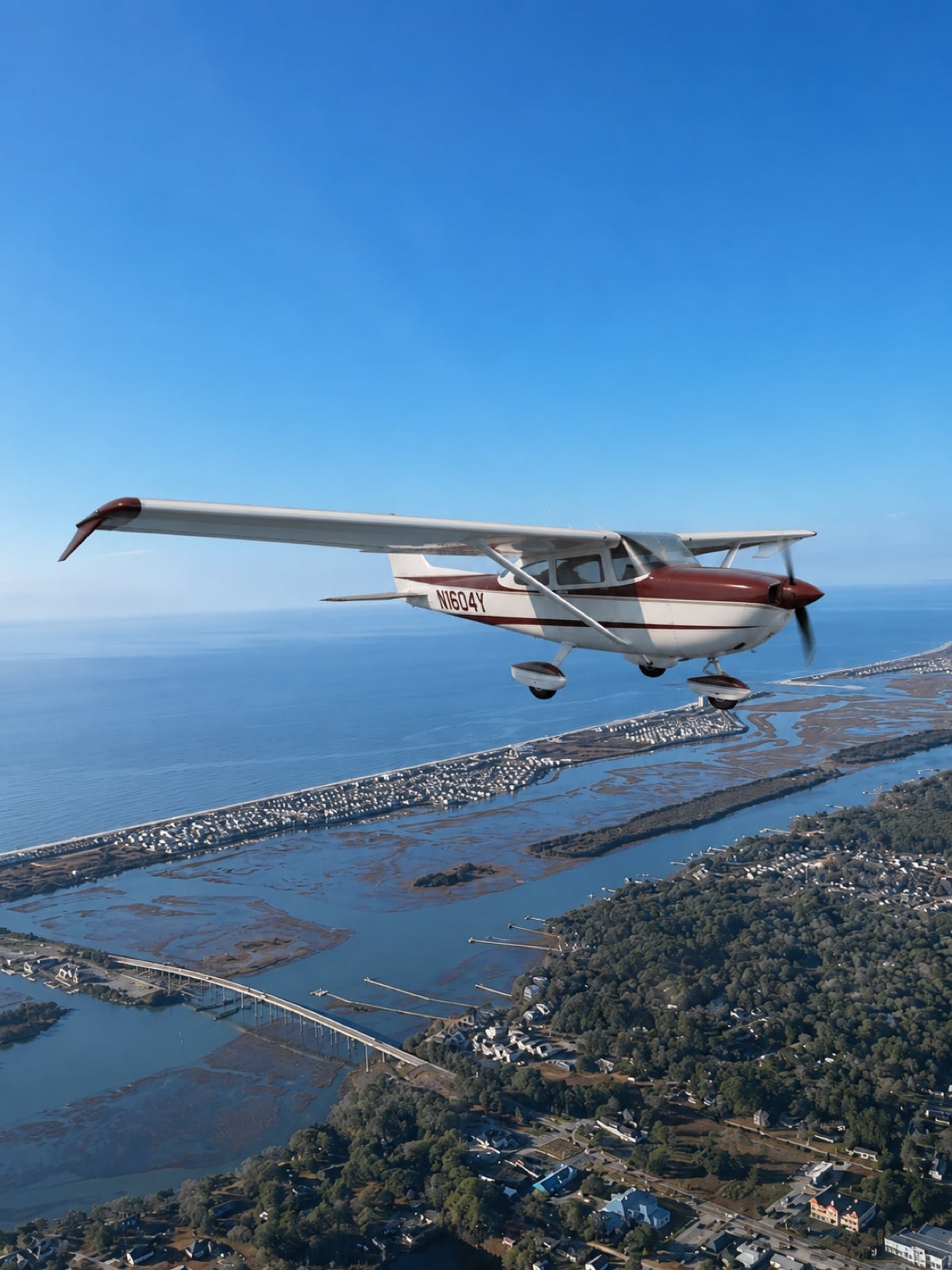 Cessna 172 flying above the Ocean Isle Beach coastline