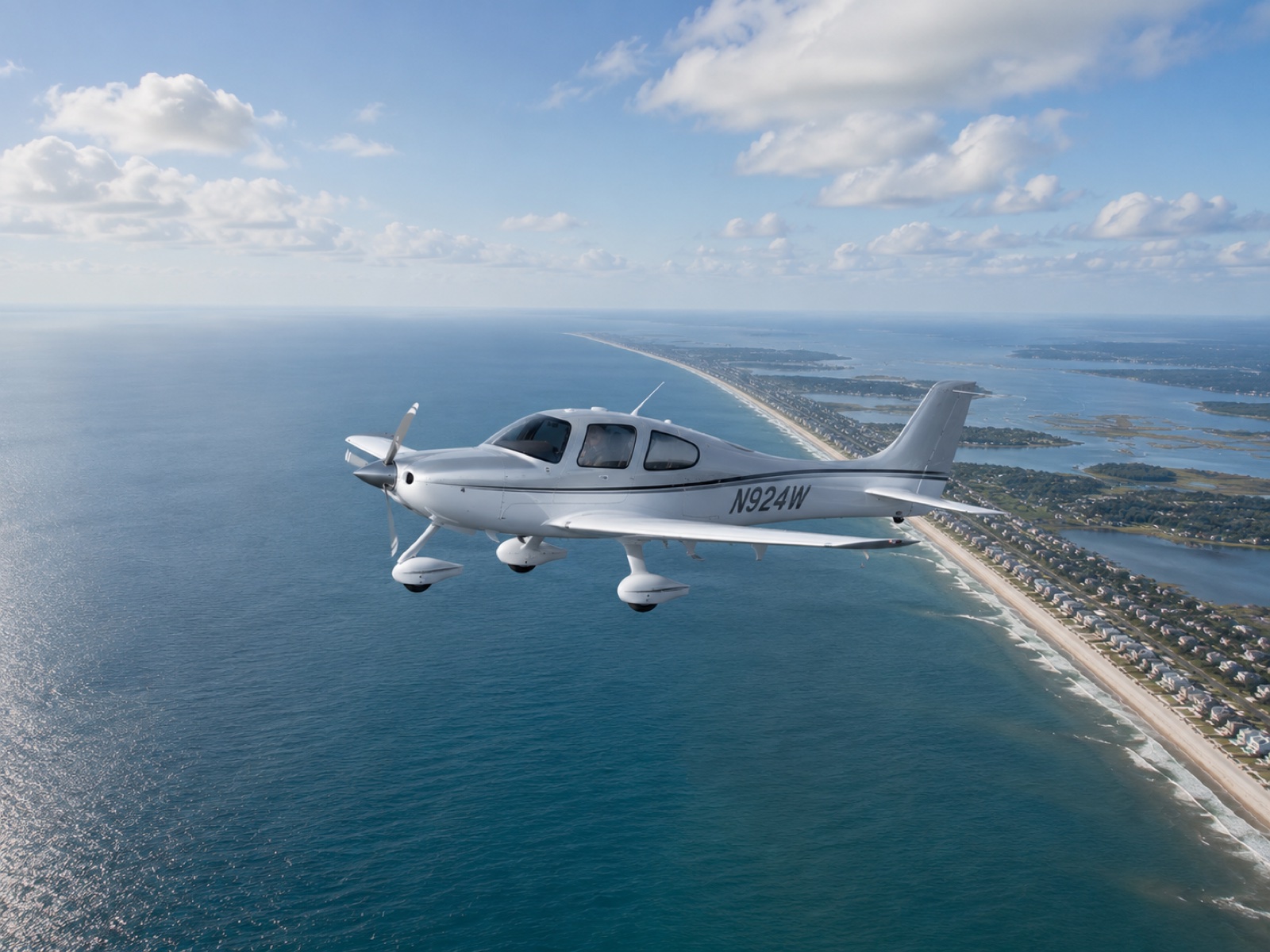 Cirrus SR-22 flying above the Ocean Isle Beach coastline
